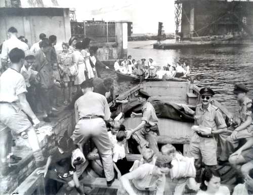 Loading Dutch refugees at Batavia, Java, for flight to Singapore